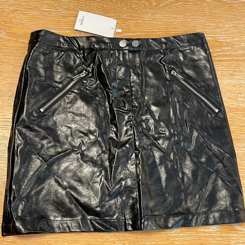 Faux leather mini skirt. Silver zippers. Silver buttons
